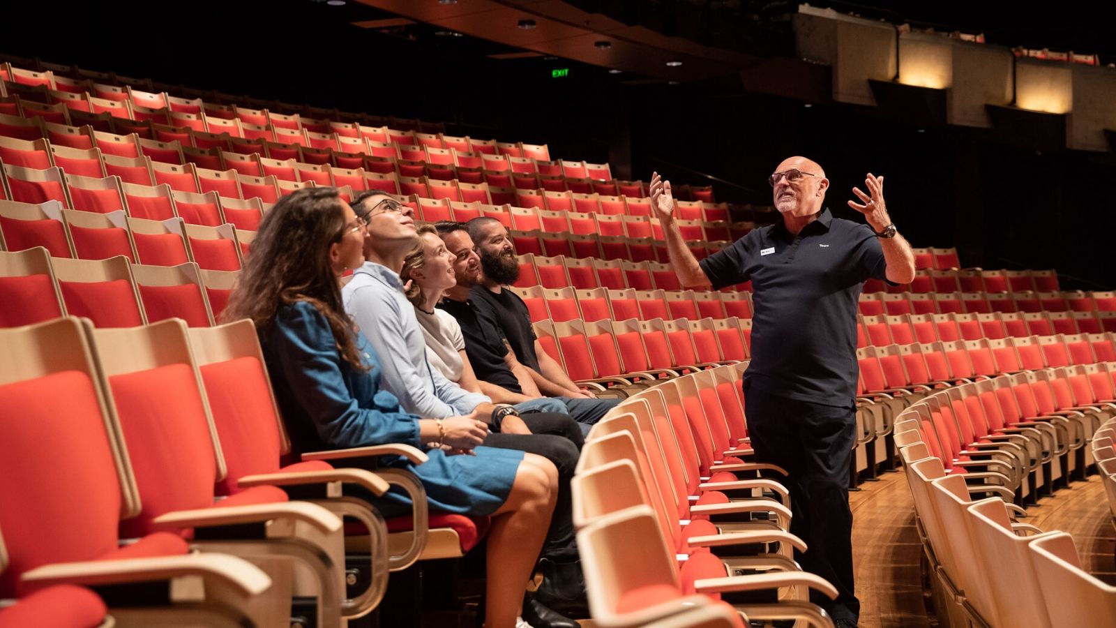 A tour guide showing the Concert Hall.