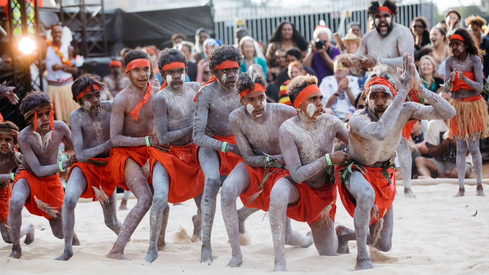 Men performing indigenous dance in the homeground of Sydney opera house.