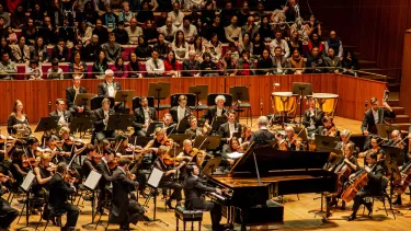 Lang Lang plays piano in front of the Sydney Symphony Orchestra in the Sydney Opera House Concert Hall