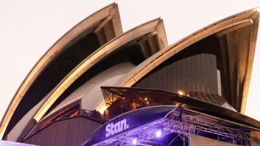 The Sydney Opera House with a stage underneath headlining 'Stan.'.