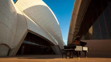 A Yamaha piano outside of the Sydney Opera House.