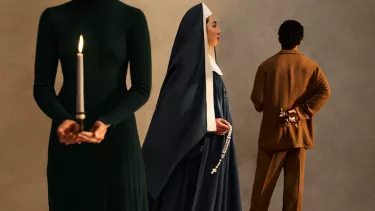 A woman dressed as a nun faces the right. Another woman wearing black holds a candle and a man faces the back wearing a copper coloured suit.