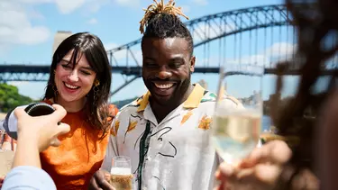 A couple enjoying food and drinks at the Opera bar.