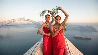 Two Aboriginal women on top of the Sydney opera house.