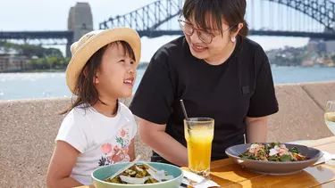 A woman and a girl having food at Opera bar.