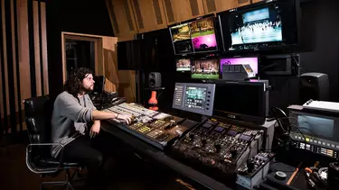A man in the control room of the Concert Hall.