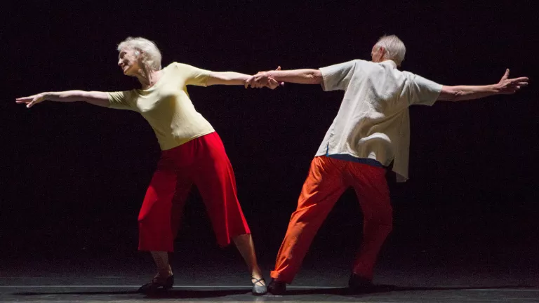 An old man and a woman dancing together.