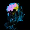 An abstract painting of a human head side profile, the brain is lit up in colour.