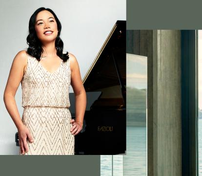 Andrea Lam a talented pianist standing close to a grand piano in a white dress.