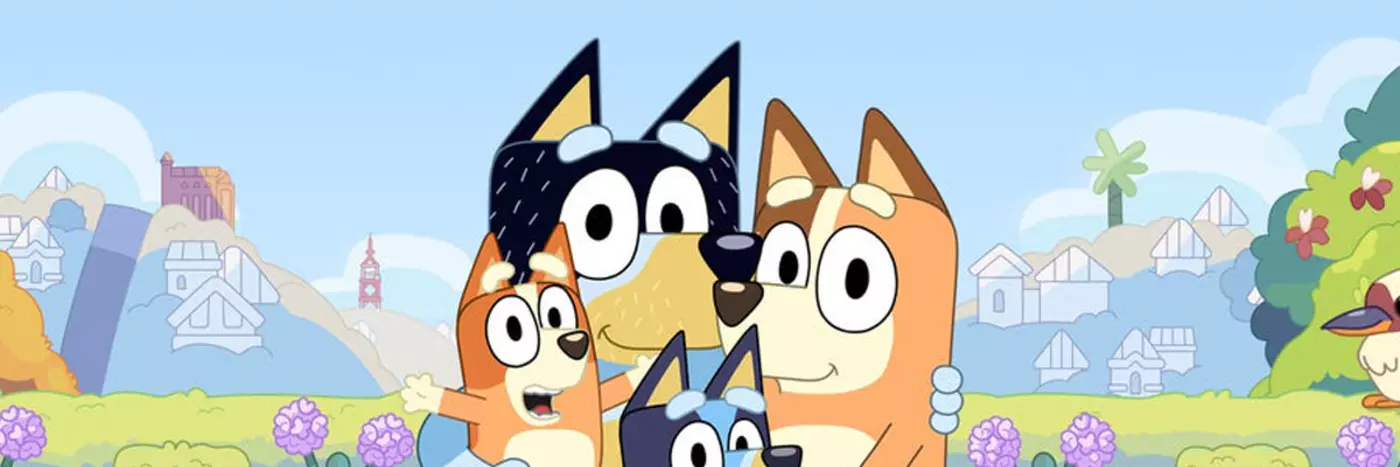 Four cartoon dogs gathered together in a field.